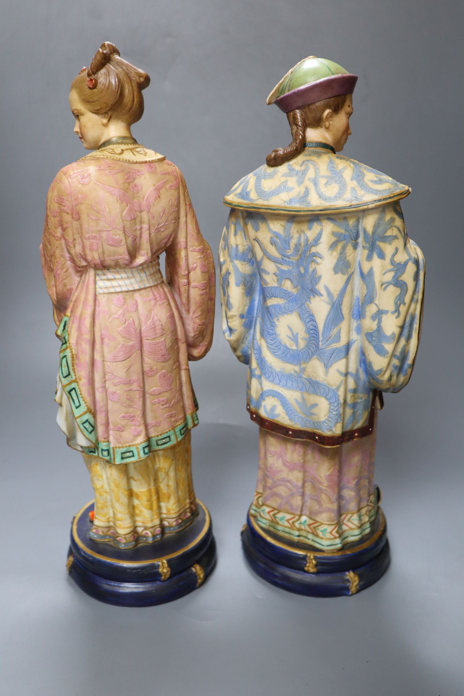 A pair of 19th century coloured bisque porcelain Oriental figures, height 38cm